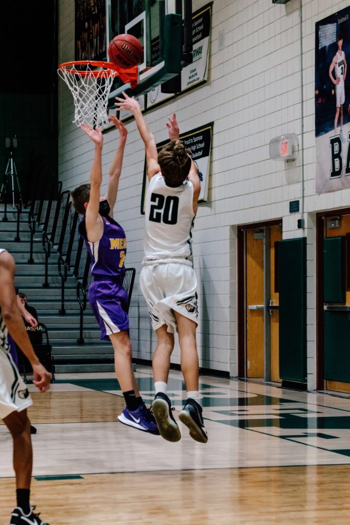 boy shooting basketball