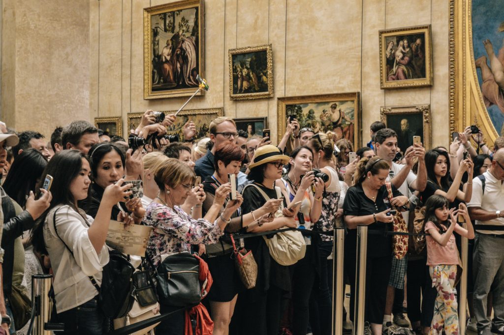People standing in front of the Mona Lisa